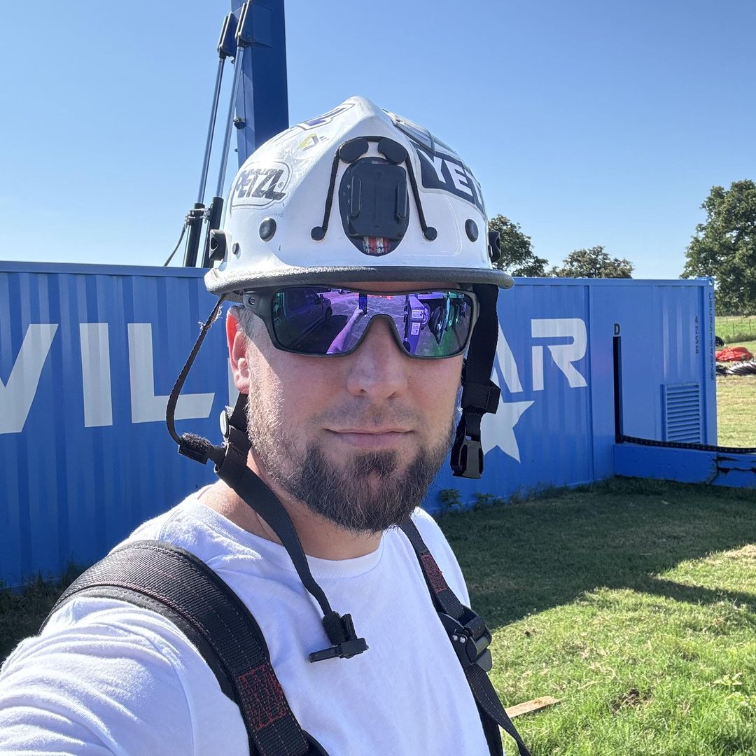 man standing in front of blue tower container